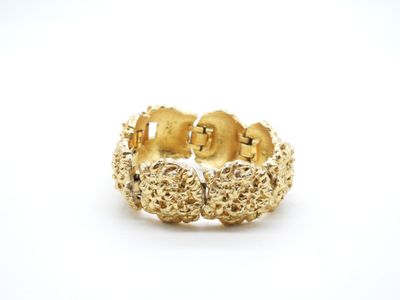 a close up of a gold ring on a white background