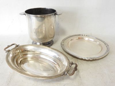 a silver plate and a silver cup on a table