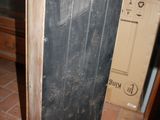 a blackboard on the floor next to a brown box