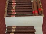 a box of cigars sitting on top of a red carpet