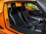 an orange sports car with black seats in the back