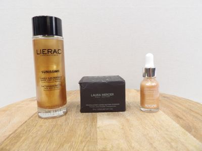a bottle of liquid next to a box of liquid on a table