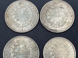 four silver coins, one of which is a sovereign and one of which is a sovereign