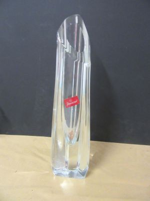 a clear glass vase with a red label on it