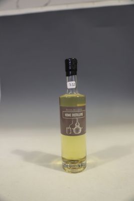 a bottle of wine sitting on a counter next to a glass of wine