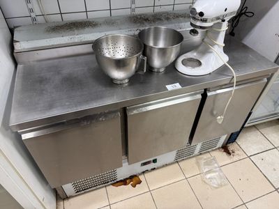 a kitchen counter with a mixer and a bowl on it