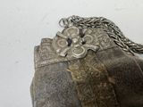 a silver purse with a chain around it