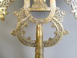 a gold mirror with a picture of a man on top of it