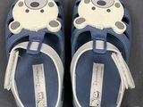 pair of blue children ' s sandals with white and black polka dots on them