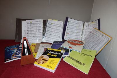 a lot of music books on a red table