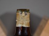 a close up of a bottle of beer on a table
