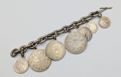 a close up of a chain bracelet with coins on it