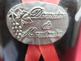 a bottle of wine with a red ribbon on it