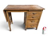 a small wooden desk with three drawers on it