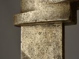 close up of a metal pole with a metal handle on a gray background