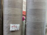 several rolls of fabric sitting on top of a shelf in a store