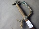 a sword that is laying on the ground with a tag on it