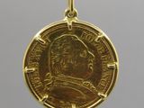 a gold coin with a portrait of a man on it
