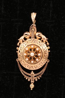 an image of a gold pendant with a clock on it