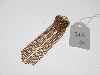 a close up of a gold chain with a tag attached to it