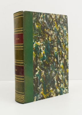 an old book sitting on top of a white table next to a white wall