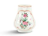 a small white vase with a floral design on it