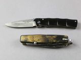 two knives that are sitting next to each other on a table