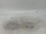 two clear glass bowls sitting on top of a white surface