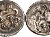 a silver coin with an image of a horse and a man on it