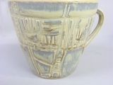 a cup that is sitting on a white table