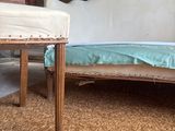 a couch and a table in a room with a painting on the wall