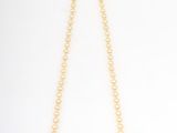 a pearl and emerald necklace with a gold clasp