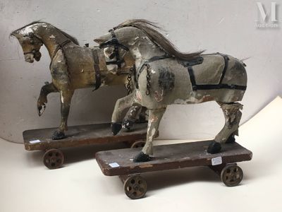 two horses that are standing on a wooden platform