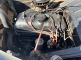 an old car engine with a lot of wires attached to it