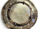 an image of a silver plate on a white background with a tag