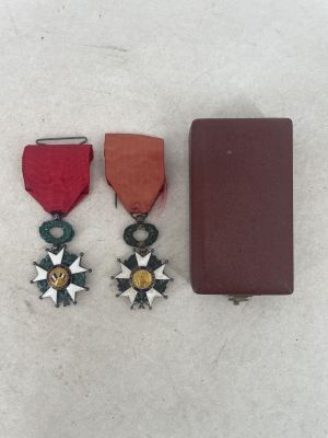 two medals and a book on a white surface