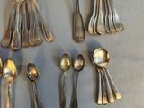 a lot of silver spoons and spoon spoons on the table
