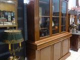 a display case with a lamp on a table in a room