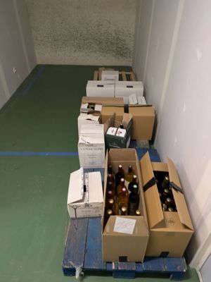 many boxes of beer sitting on a pallet in the hallway