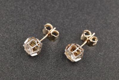 une paire de boucles d'oreilles en diamant sur un fond noir