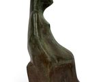 an image of a sculpture of a bird sitting on a wooden block