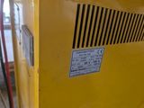 a yellow machine that is sitting in a room