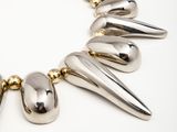 a close up of a necklace with spikes on it