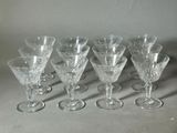 six wine glasses are lined up in a row on a table