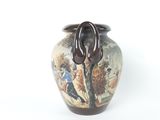 a vase with a painting on it sitting on a table