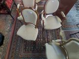 several chairs and a table in a room with a rug on the floor