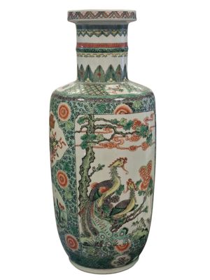 a vase with a bird on it sitting on a table