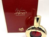 an image of a bottle of perfume sitting next to a box