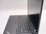 a black laptop with a red button on the keyboard