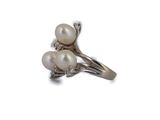 an image of a white pearl and diamond ring on a white background